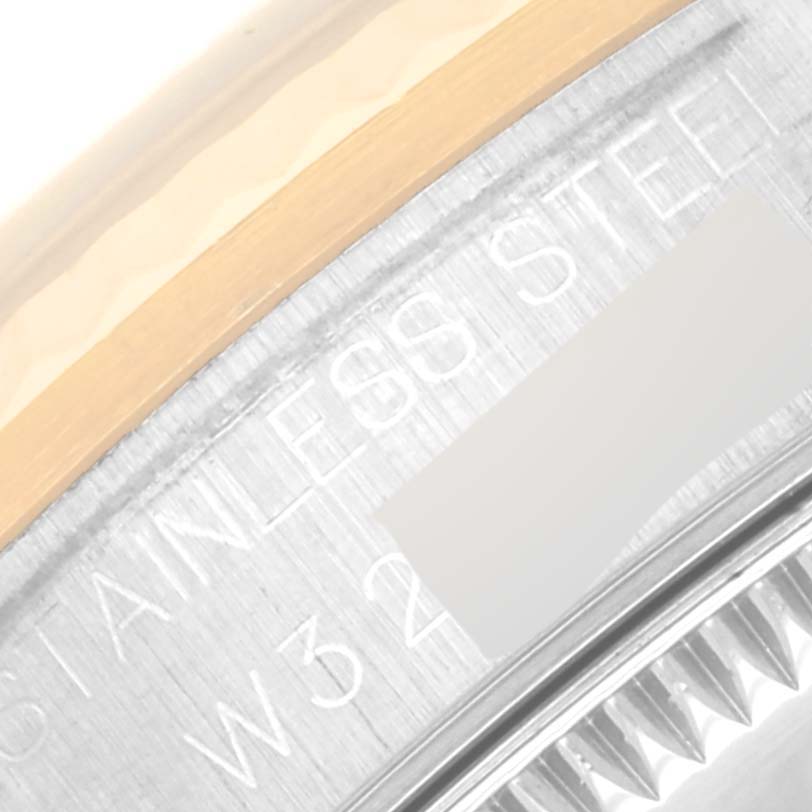 This close-up image of a Rolex Mid-Size 68273 Women's Steel and Gold (two tone) Blue Dial 68273 Women's Steel and Gold (two tone) Blue Dial watch shows the edge of the stainless steel case with part of the serial number.