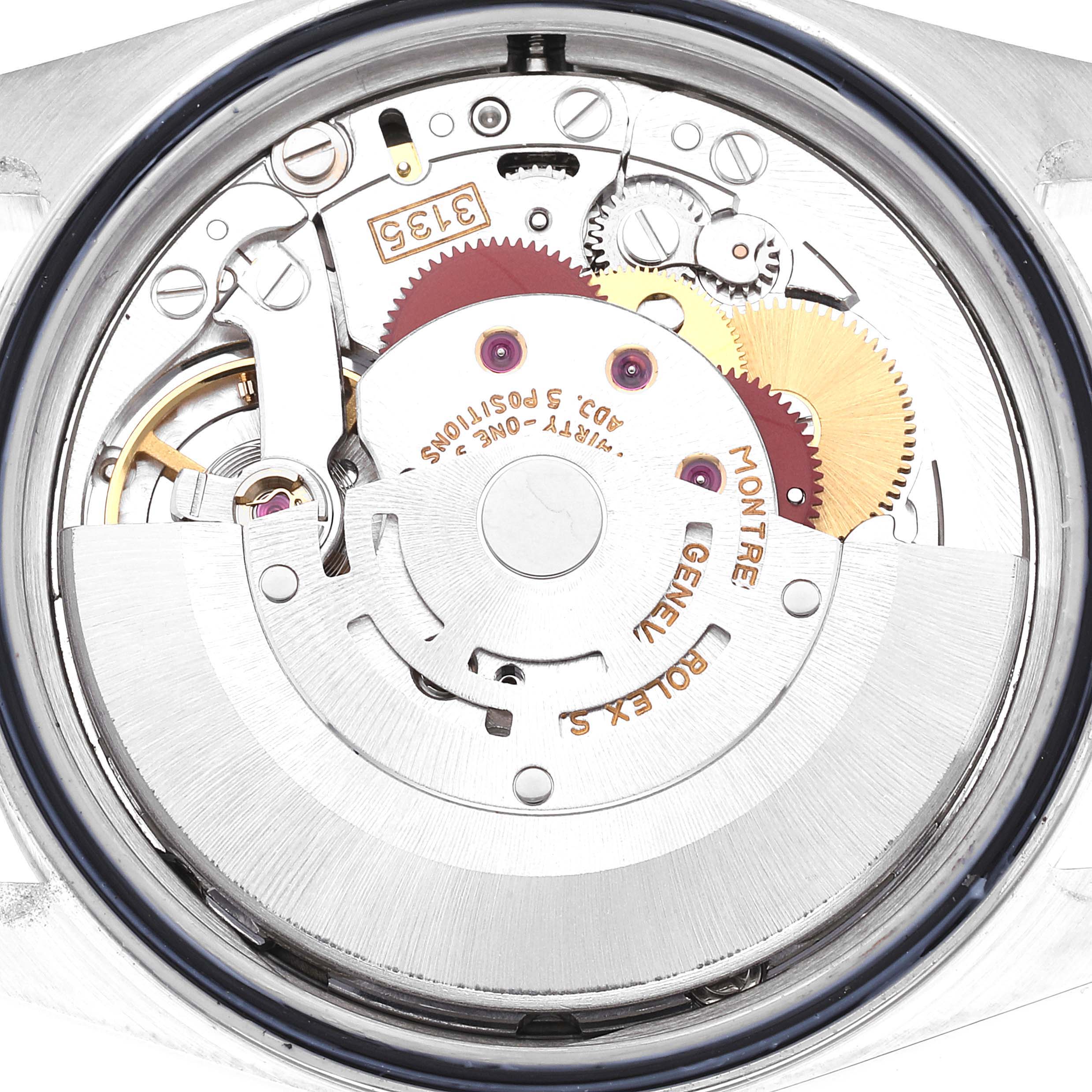 The image shows a close-up of the internal movement of a Rolex Datejust 16220 Men's Stainless Steel Silver Dial 16220 Men's Stainless Steel Silver Dial watch, highlighting gears, cogs, and the rotor.