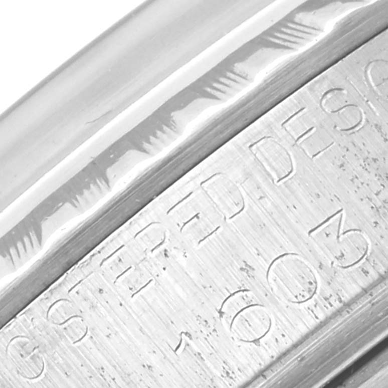 This close-up image shows the engraved details of the bezel and case edges of the Rolex Vintage Collection 1603 Men's Stainless Steel Silver Dial 1603 Men's Stainless Steel Silver Dial watch.