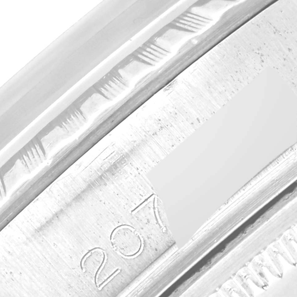 This close-up image shows the engraved serial number on the metal rim of the Rolex Vintage Collection 1603 Men's Stainless Steel Silver Dial 1603 Men's Stainless Steel Silver Dial watch.