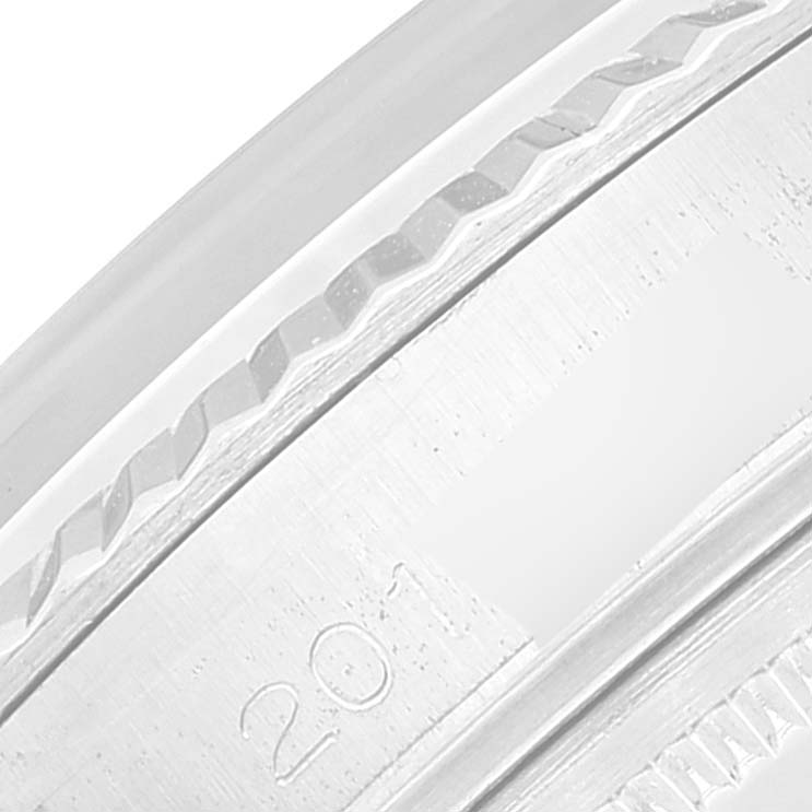 This image shows a close-up of the fluted bezel and part of the engraved rehaut of a Rolex Datejust 1601 Men's Stainless Steel Silver Dial 1601 Men's Stainless Steel Silver Dial watch.