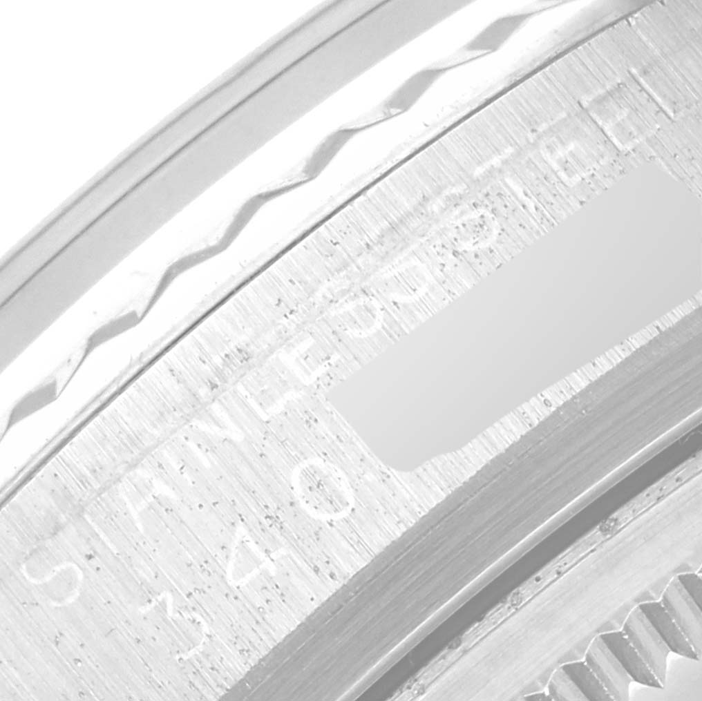 The image shows a close-up view of the edge and engraved markings on the case back of a Rolex Vintage Collection 1601 Men's Stainless Steel Silver Dial 1601 Men's Stainless Steel Silver Dial watch.