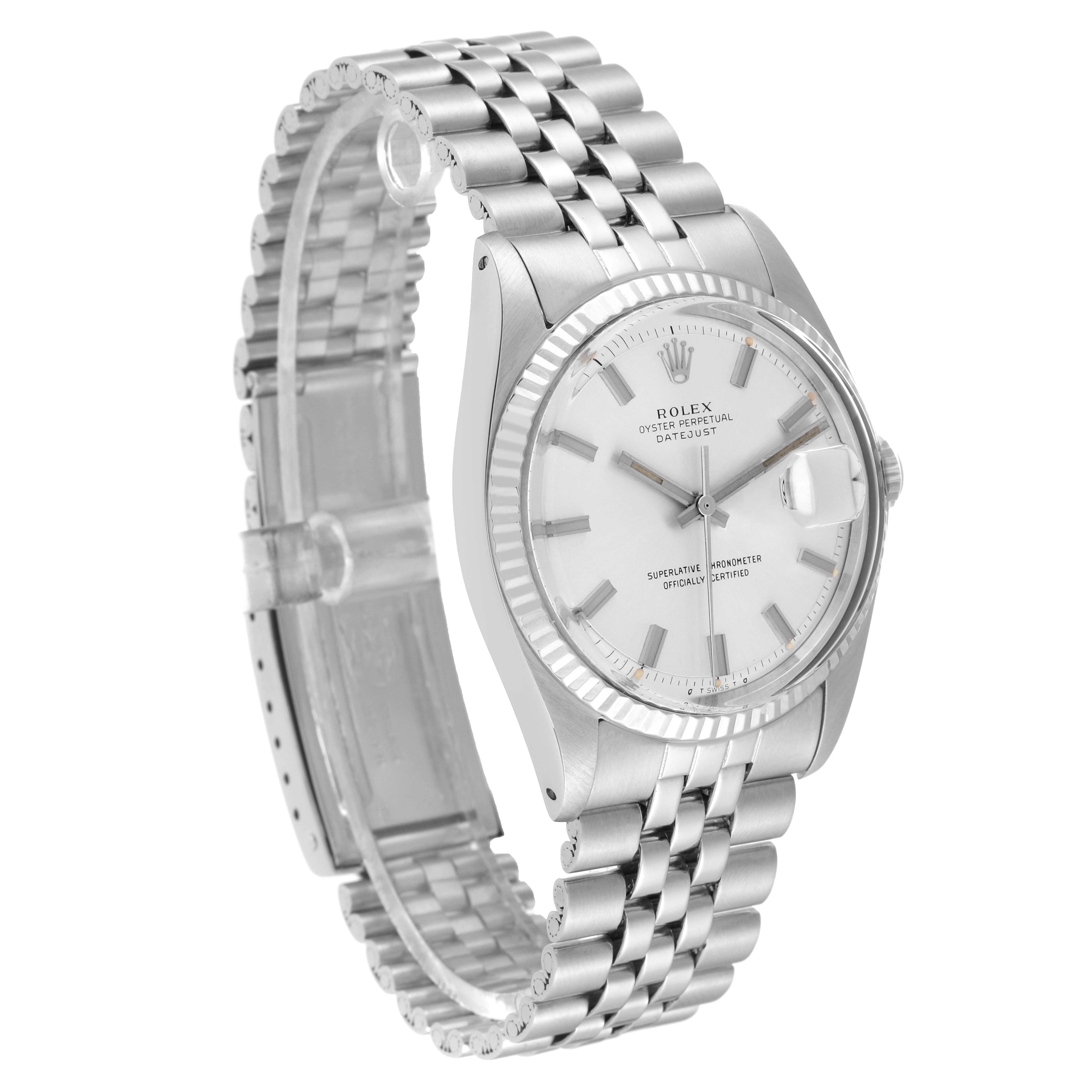 The Vintage Collection Rolex watch is shown at a slight angle, highlighting its silver dial, fluted bezel, and jubilee bracelet.