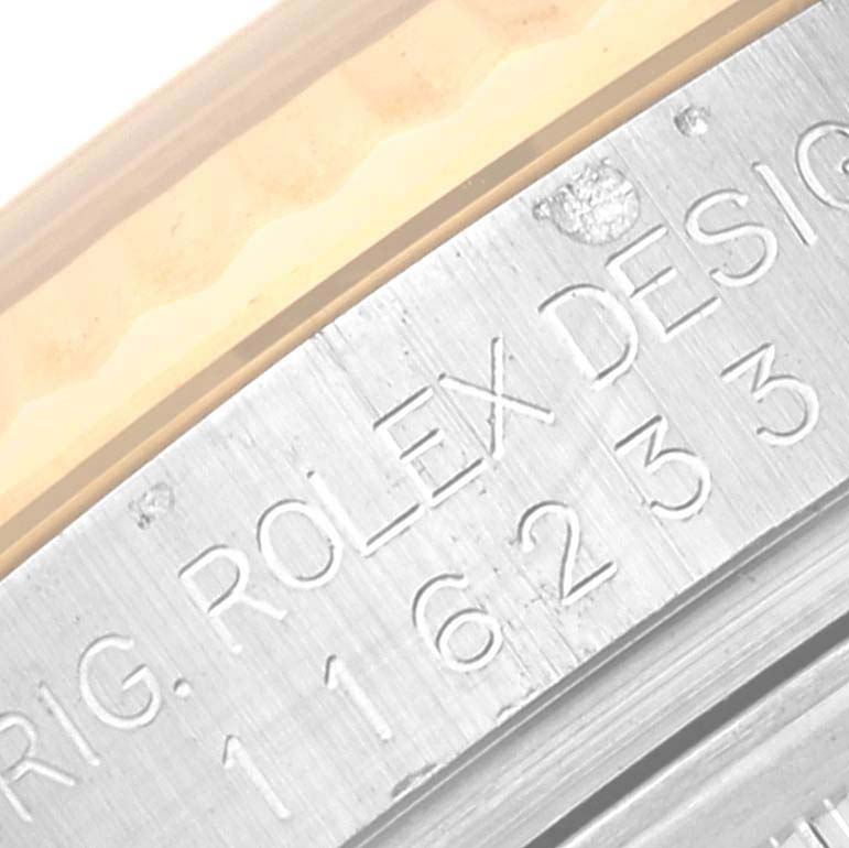 This image shows a close-up angle of the engraved case back of a Rolex Datejust 116233 Men's Steel and Gold (two tone) Blue Dial 116233 Men's Steel and Gold (two tone) Blue Dial watch.