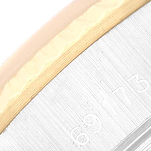 This close-up image shows the side view of a Datejust Rolex watch bezel and case, highlighting the serial number engravings.
