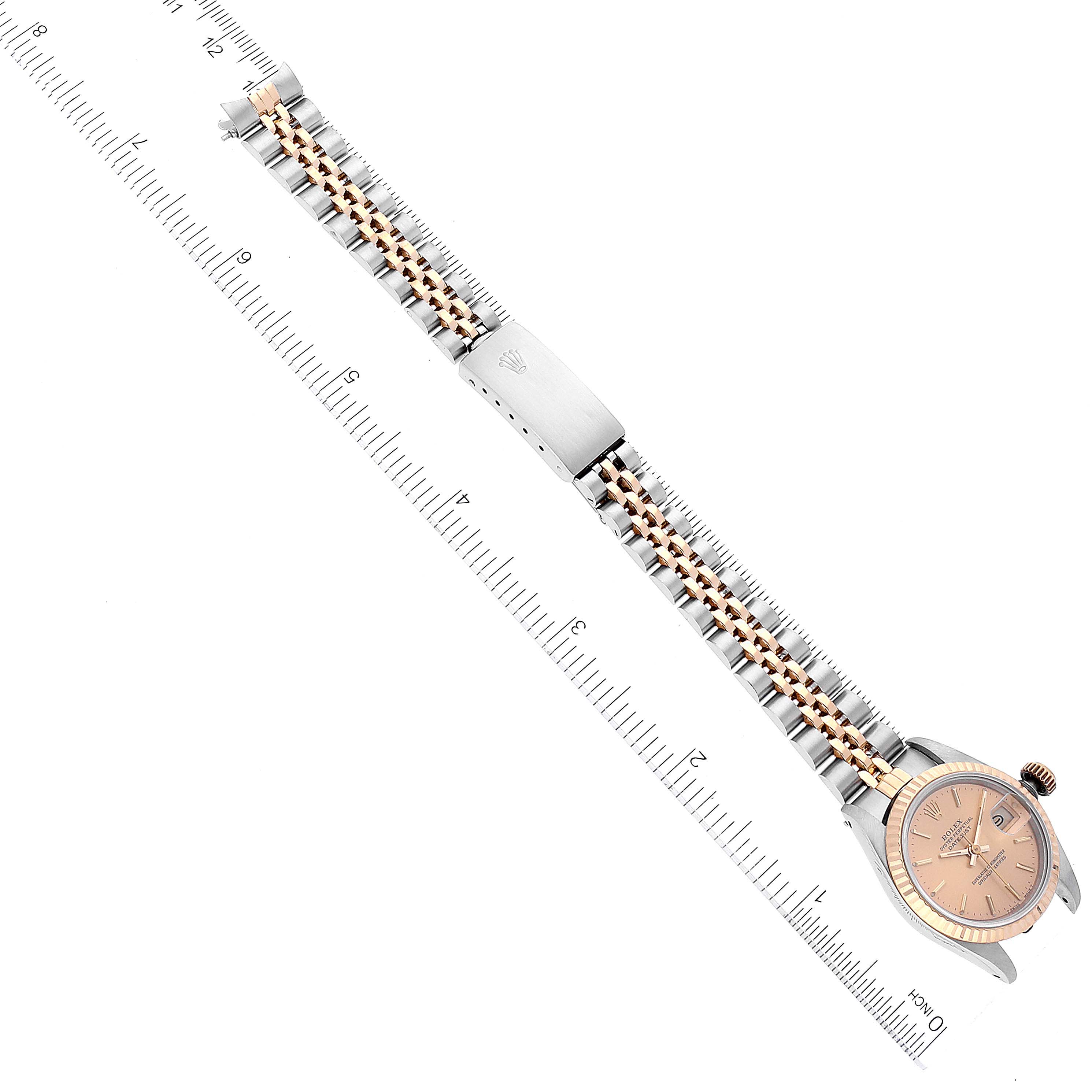 The image shows the Rolex Datejust 69173 Women's Steel and Gold (two tone) Champagne Dial 69173 Women's Steel and Gold (two tone) Champagne Dial watch from a top-down angle, highlighting the face and the full bracelet between two rulers for scale.