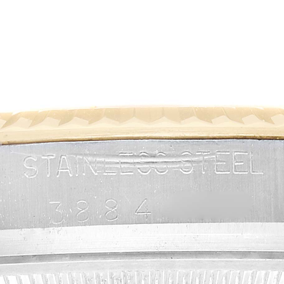 This image shows a close-up side view of the bezel and case of a Rolex Datejust 1601 Men's Steel and Gold (two tone) Champagne Dial 1601 Men's Steel and Gold (two tone) Champagne Dial watch, highlighting the engraved "STAINLESS STEEL."