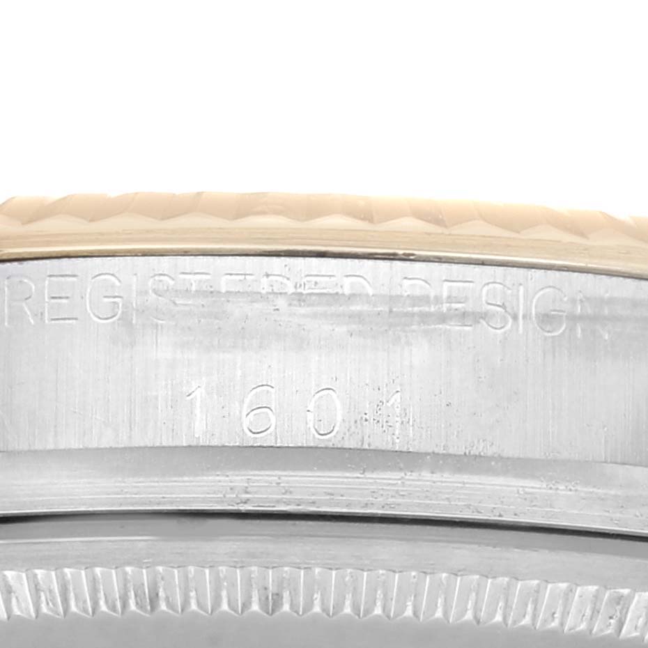 The image shows a close-up of the case side of a Rolex Datejust 1601 Men's Steel and Gold (two tone) Champagne Dial 1601 Men's Steel and Gold (two tone) Champagne Dial, displaying the model number "1601" and "REGISTERED DESIGN" engraving.