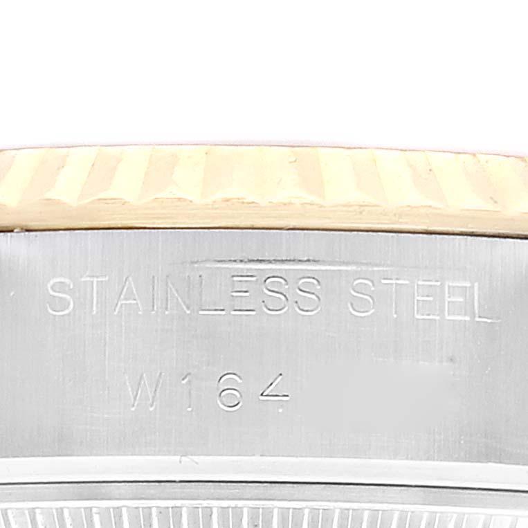 This image shows a close-up of the stainless steel casing of a Rolex Datejust 69173 Women's Steel and Gold (two tone) Champagne Dial 69173 Women's Steel and Gold (two tone) Champagne Dial watch, displaying part of the serial number.