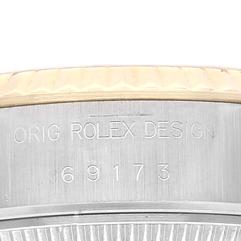 This image shows a close-up of the side of a Rolex Datejust 69173 Women's Steel and Gold (two tone) Champagne Dial 69173 Women's Steel and Gold (two tone) Champagne Dial watch, highlighting the model number and "ORIG ROLEX DESIGN" engraving.