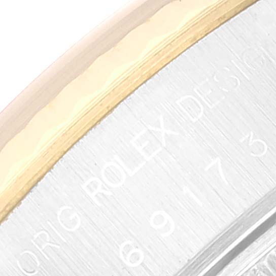 The image shows a close-up angle of the Rolex Datejust 69173 Women's Steel and Gold (two tone) Champagne Dial 69173 Women's Steel and Gold (two tone) Champagne Dial watch, highlighting part of the bezel and the engraved text on the case side.