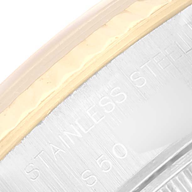 This image shows a close-up angle of the bezel and part of the case of a Rolex Datejust 69173 Women's Steel and Gold (two tone) Champagne Dial 69173 Women's Steel and Gold (two tone) Champagne Dial watch, highlighting the "STAINLESS STEEL" engraving.