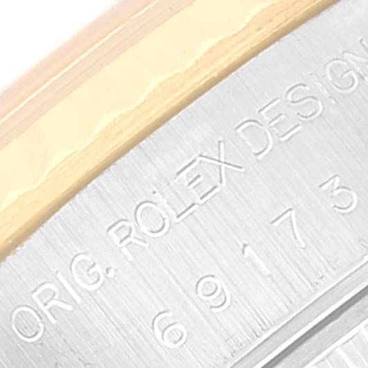 This close-up image shows the edge of the case back of a Rolex Datejust 69173 Women's Steel and Gold (two tone) Champagne Dial 69173 Women's Steel and Gold (two tone) Champagne Dial watch, highlighting the engraved text and part of the bezel.