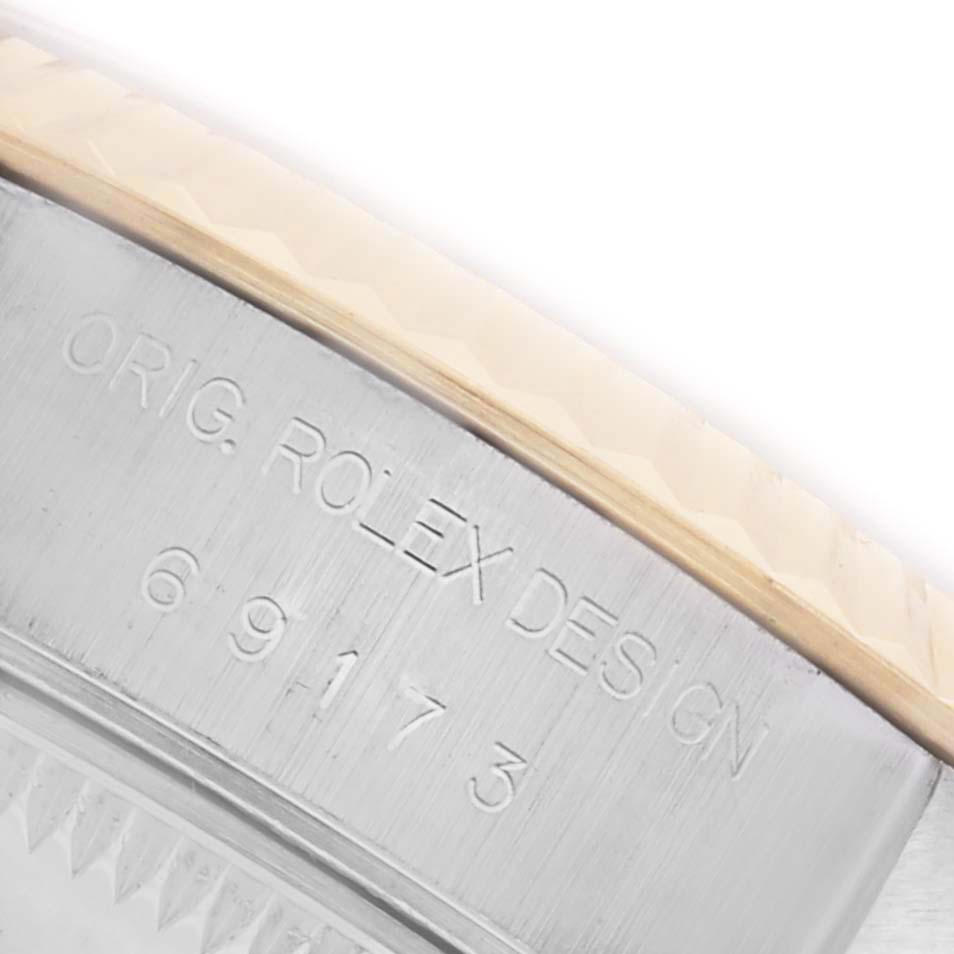 The image shows the engraved side of the bezel on a Rolex Datejust 69173 Women's Steel and Gold (two tone) Champagne Dial 69173 Women's Steel and Gold (two tone) Champagne Dial watch at a close-up angle.