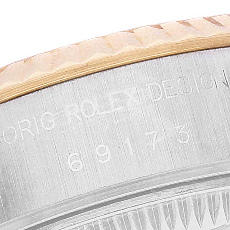 Close-up of the engraved edge and fluted bezel of a Rolex Datejust 69173 Women's Steel and Gold (two tone) Grey Dial 69173 Women's Steel and Gold (two tone) Grey Dial watch.