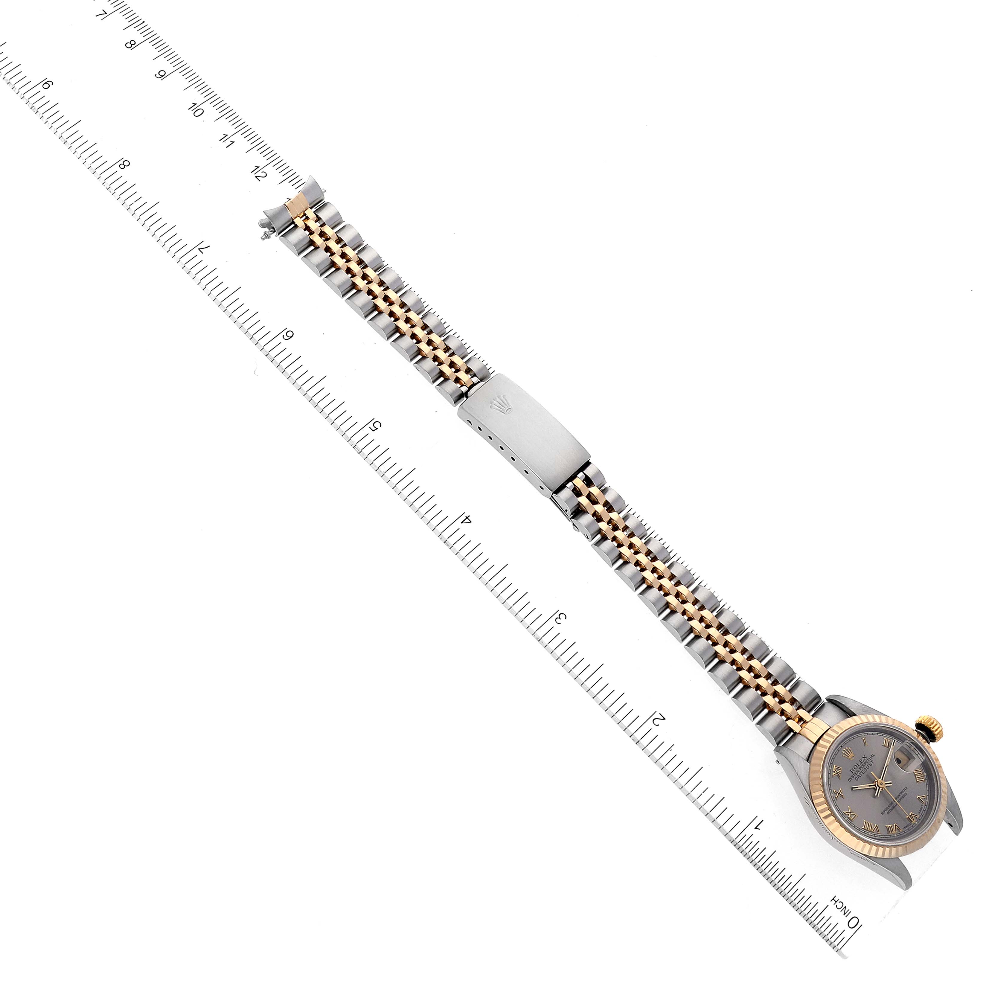 The Rolex Datejust 69173 Women's Steel and Gold (two tone) Grey Dial 69173 Women's Steel and Gold (two tone) Grey Dial watch is displayed flat with a ruler beside it, showing the band and face from a top-down angle.
