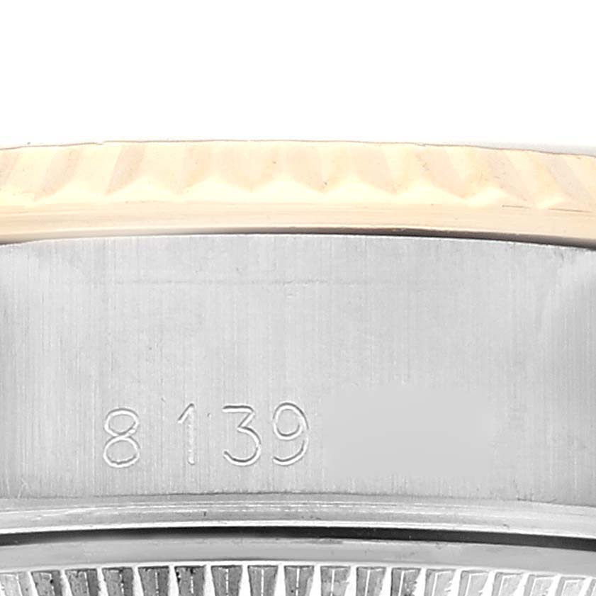 The image shows a close-up of the serial number and fluted bezel on a Rolex Datejust 69173 Women's Steel and Gold (two tone) White Dial 69173 Women's Steel and Gold (two tone) White Dial watch.
