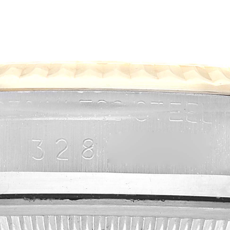 This is a close-up of the side of a Rolex Datejust 1601 Men's Steel and Gold (two tone) Champagne Dial 1601 Men's Steel and Gold (two tone) Champagne Dial watch, showing part of the bezel and case with visible engravings.