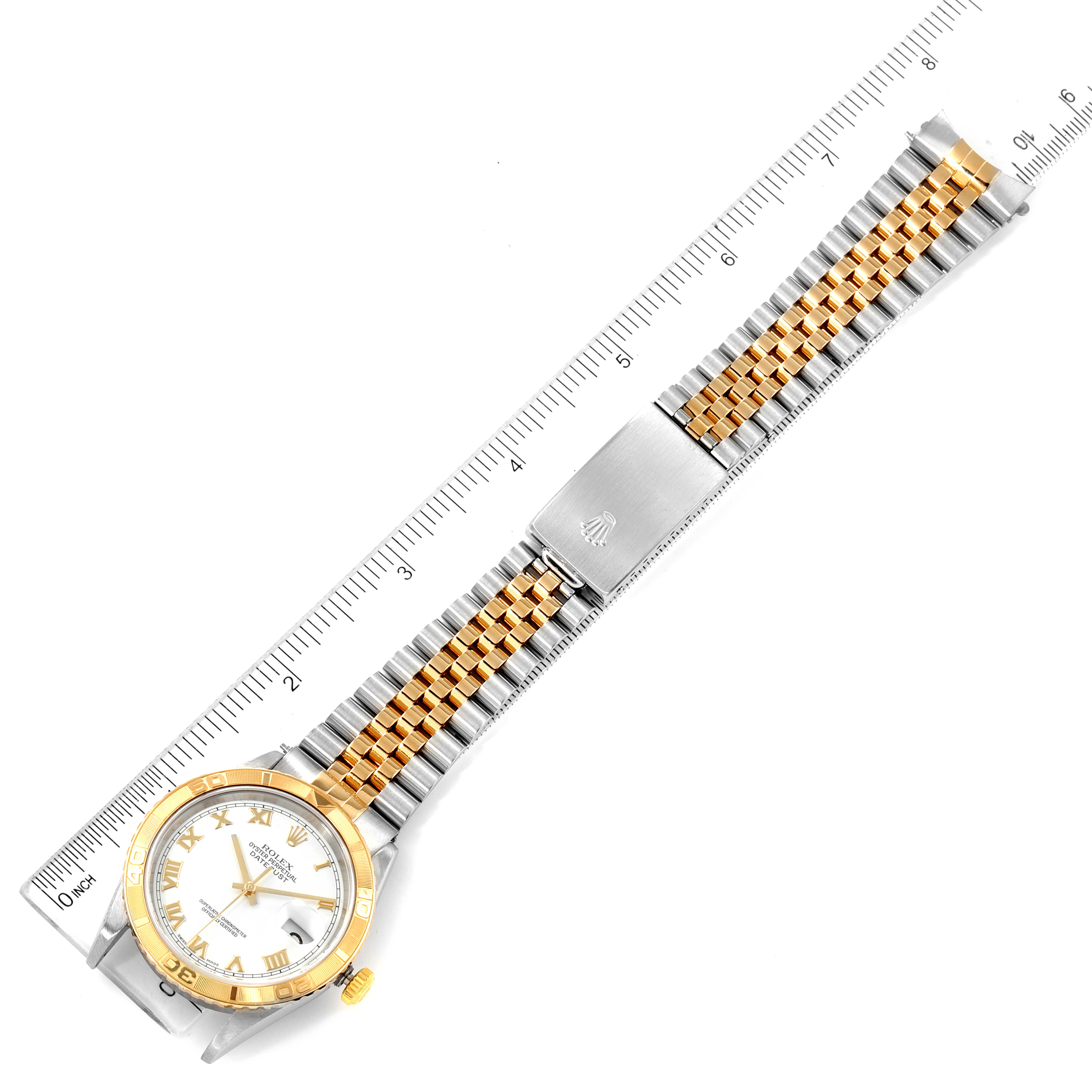 The image shows a flat lay of a Rolex Turn-o-Graph 16263 Men
s Steel and Gold (two tone) White Dial 16263 Men
s Steel and Gold (two tone) White Dial watch, displaying the watch face, bracelet, and clasp with a ruler for scale.