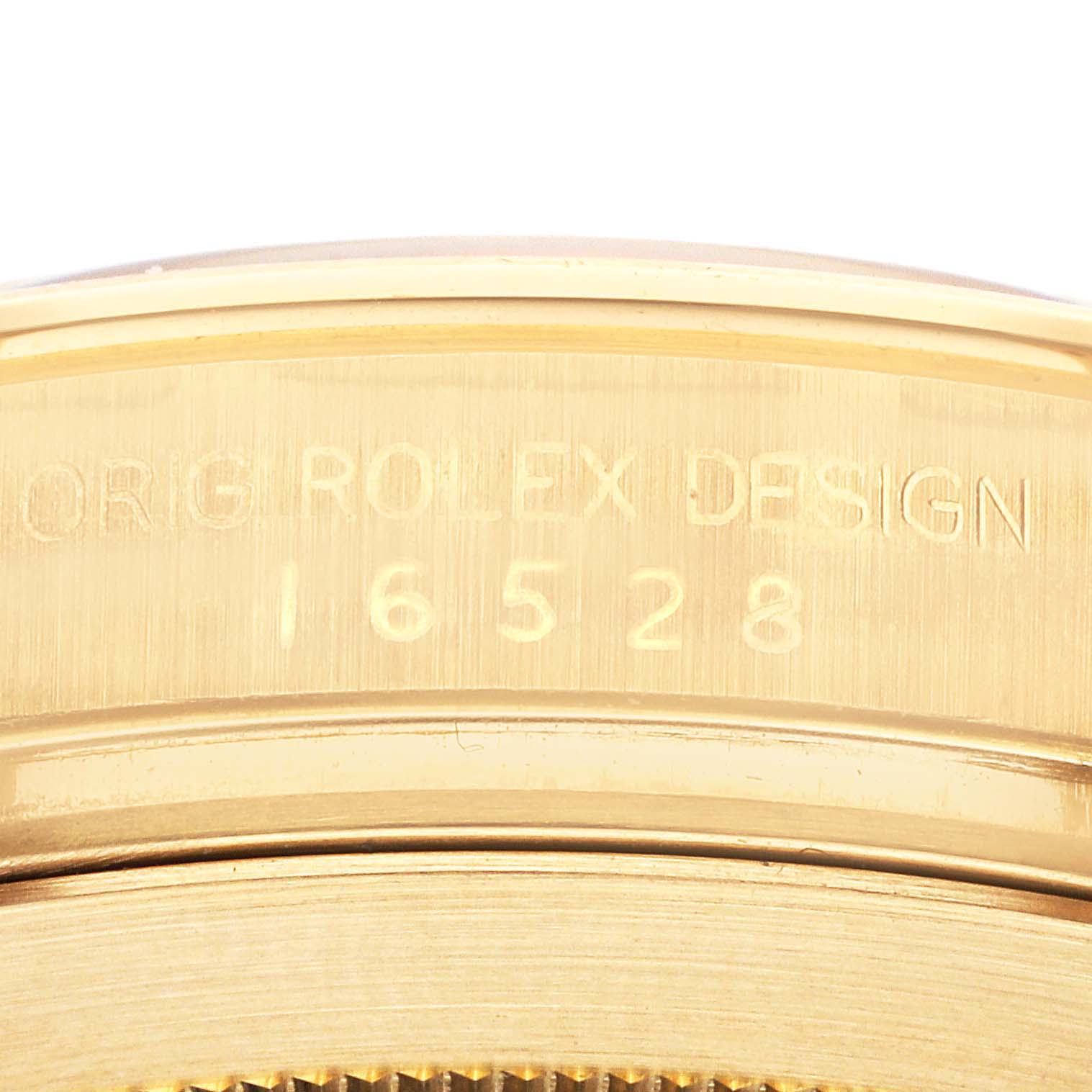 This image shows a close-up of the case back of a Rolex Daytona 16528G Men's Yellow Gold Black Dial 16528G Men's Yellow Gold Black Dial watch, focusing on the model number engraving.