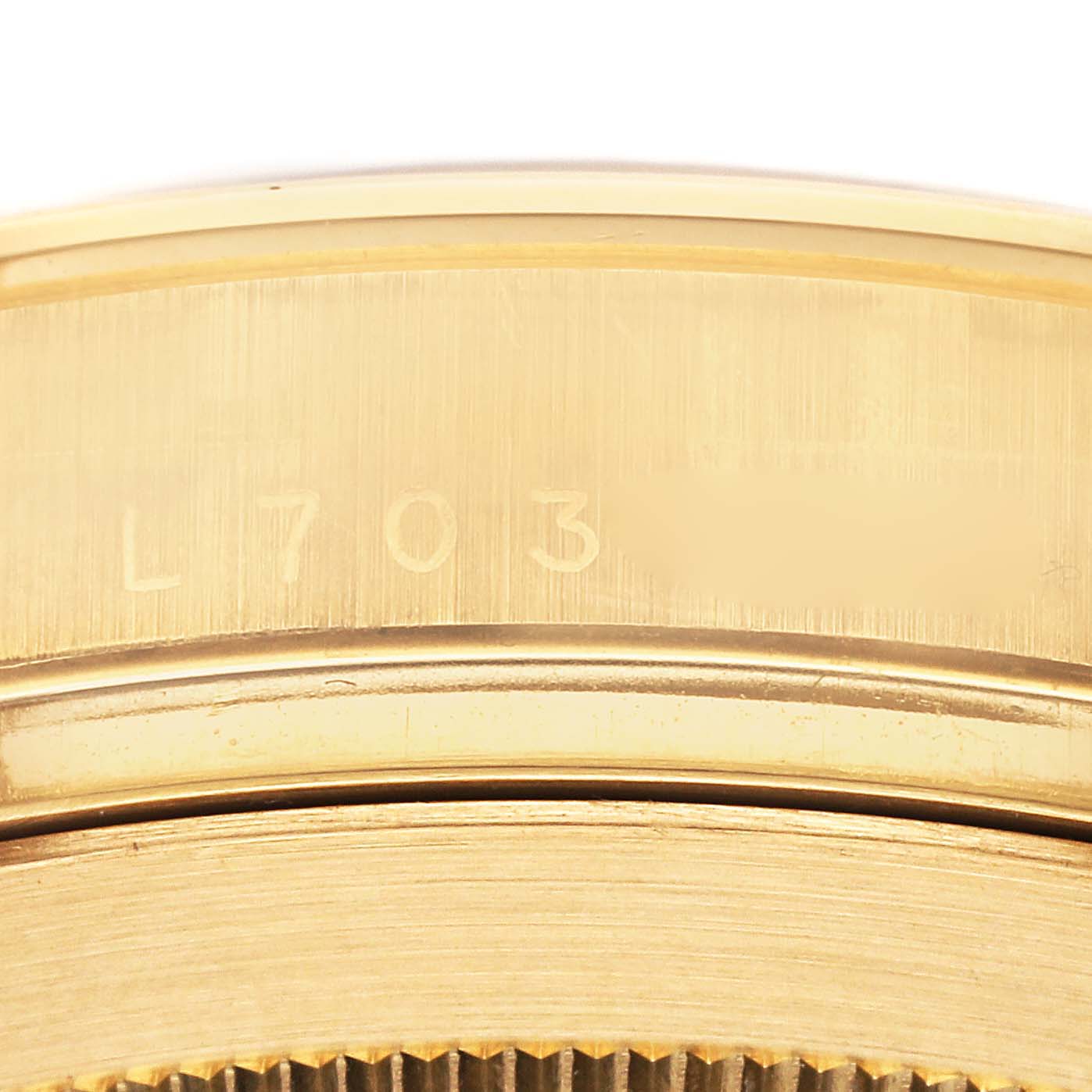 This image shows a close-up of the engraved serial number on the side of a Rolex Daytona 16528G Men's Yellow Gold Black Dial 16528G Men's Yellow Gold Black Dial watch.