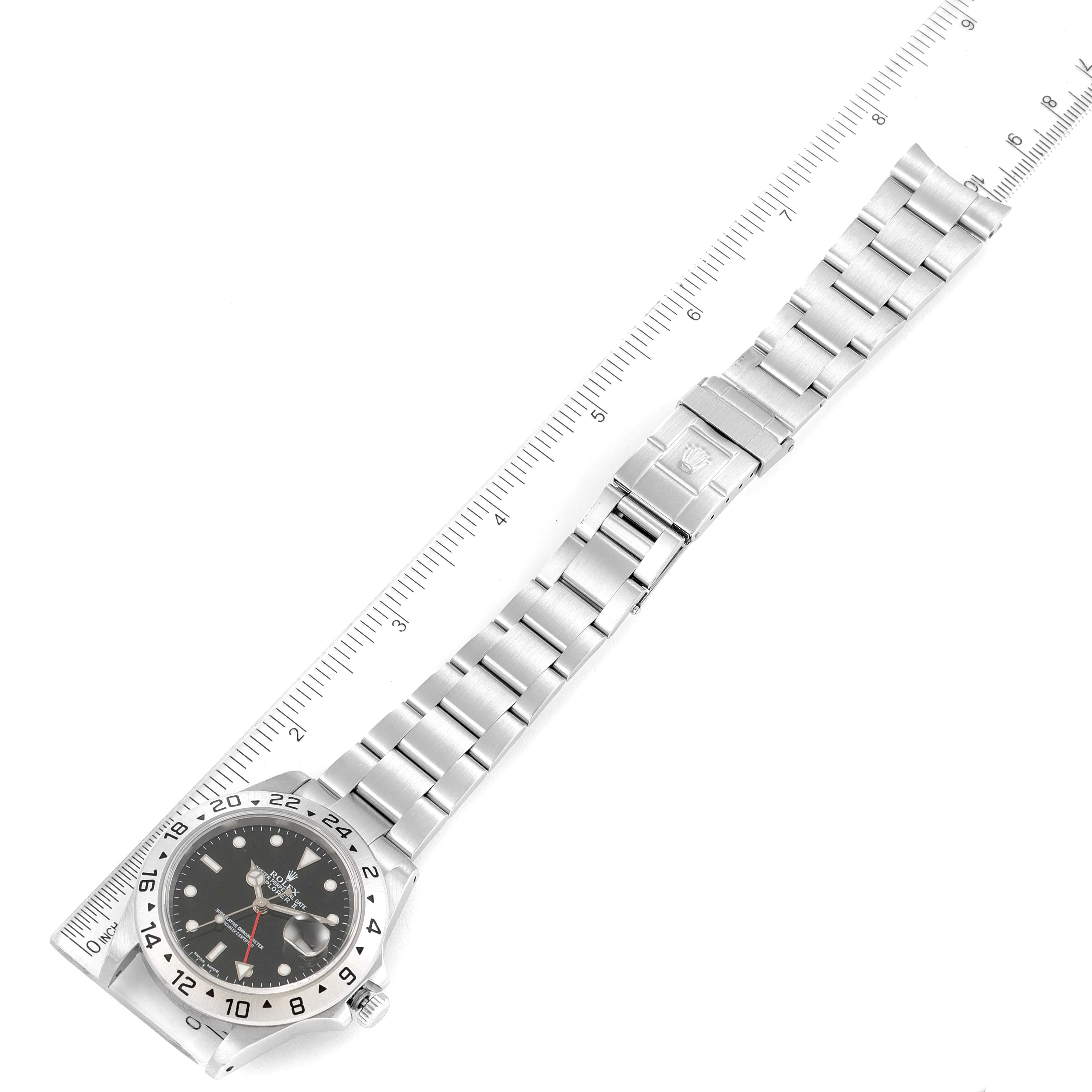 The image shows a full view of a Rolex Explorer 16570 Men's Stainless Steel Black Dial 16570 Men's Stainless Steel Black Dial model watch, including its face and metal bracelet, positioned next to a ruler.