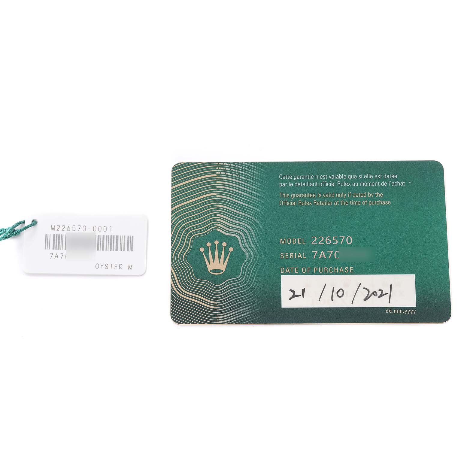 The image shows a Rolex Explorer 226570 Men
s Stainless Steel White Dial 226570 Men
s Stainless Steel White Dial model 226570 warranty card and a tag, both laid out flat.