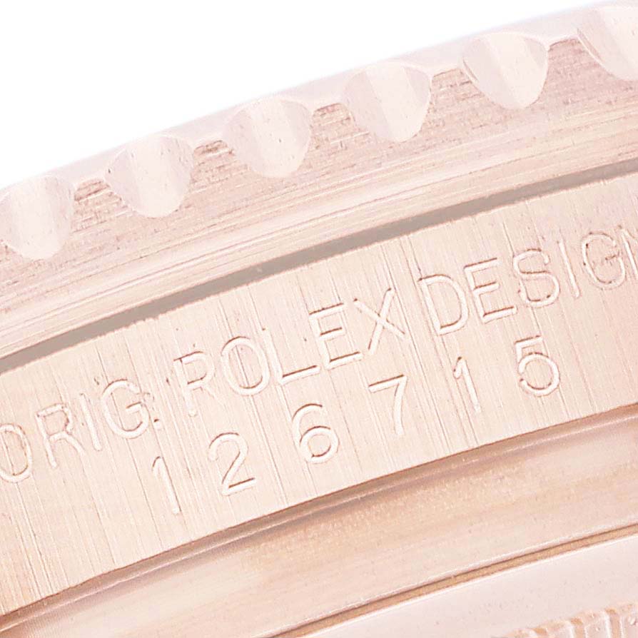 The image shows a close-up of the side of a Rolex GMT-Master 126715 Men's Rose Gold Black Dial 126715 Men's Rose Gold Black Dial with the model number 126715 engraved.