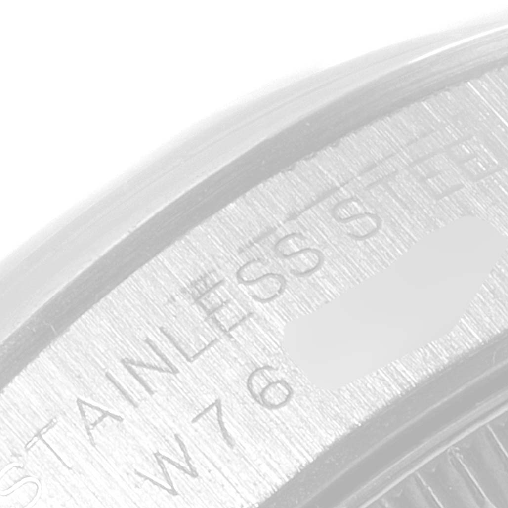 The image shows a close-up of the engraved back casing of a Rolex Oyster Perpetual 67180 Women's Stainless Steel White Dial 67180 Women's Stainless Steel White Dial watch, highlighting the "STAINLESS STEEL" text.