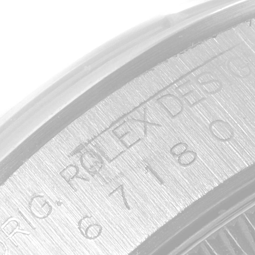 This image shows a close-up of the engraved edge of the bezel on a Rolex Oyster Perpetual 67180 Women's Stainless Steel White Dial 67180 Women's Stainless Steel White Dial watch.