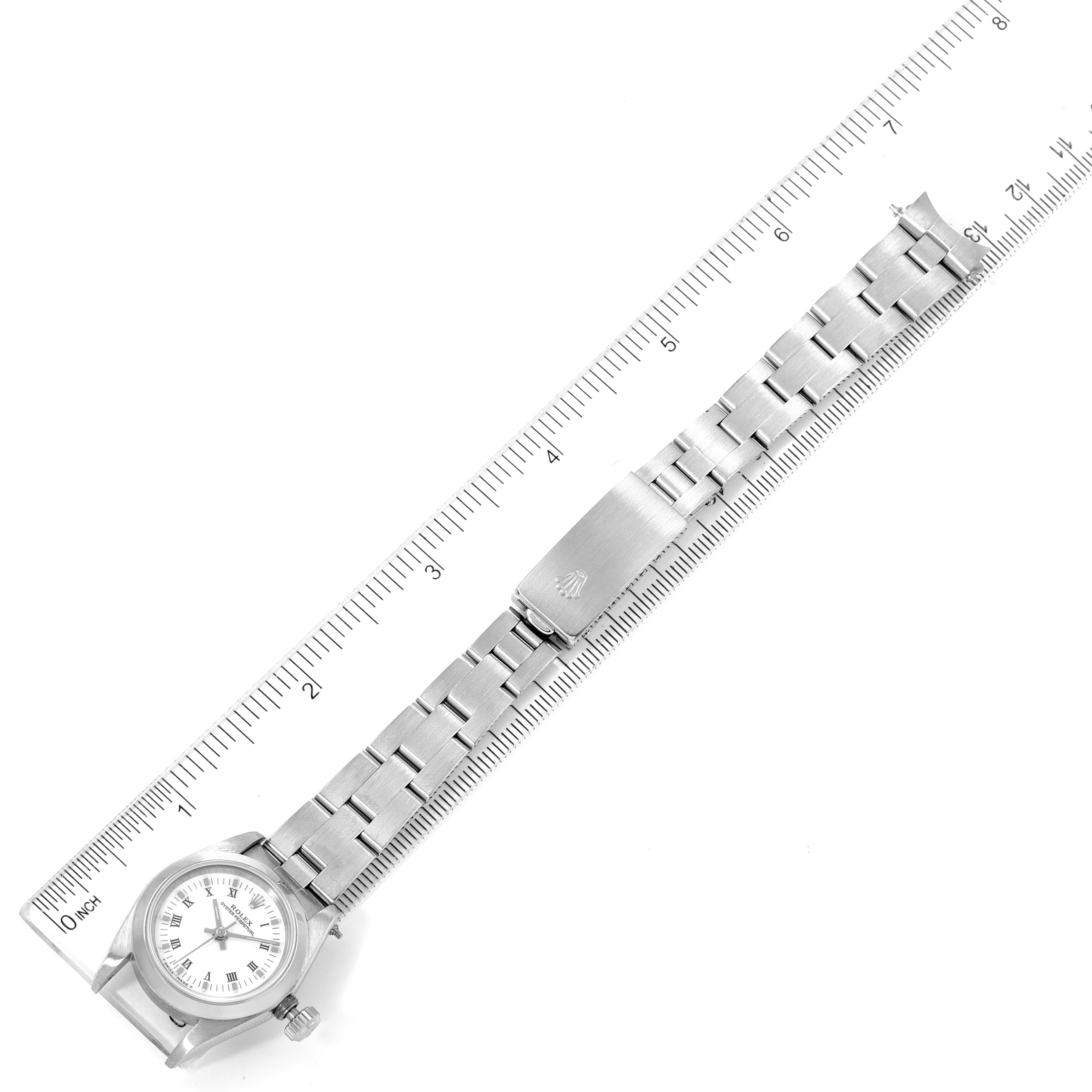 The image shows a full-length view of a Rolex Oyster Perpetual 67180 Women's Stainless Steel White Dial 67180 Women's Stainless Steel White Dial watch, including the case, dial, and bracelet with clasp, measured against a ruler.