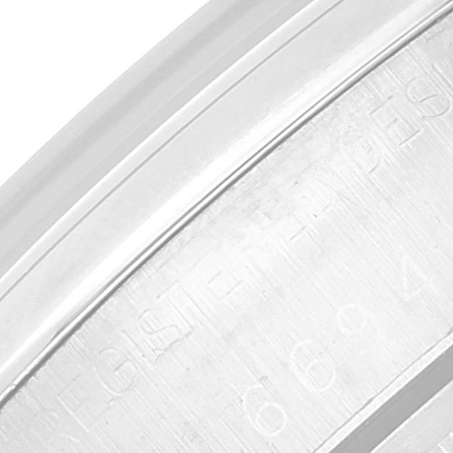 This close-up image shows the engraved text on the inner bezel of a Rolex Vintage Collection 6694 Men's Stainless Steel Black Dial 6694 Men's Stainless Steel Black Dial watch.