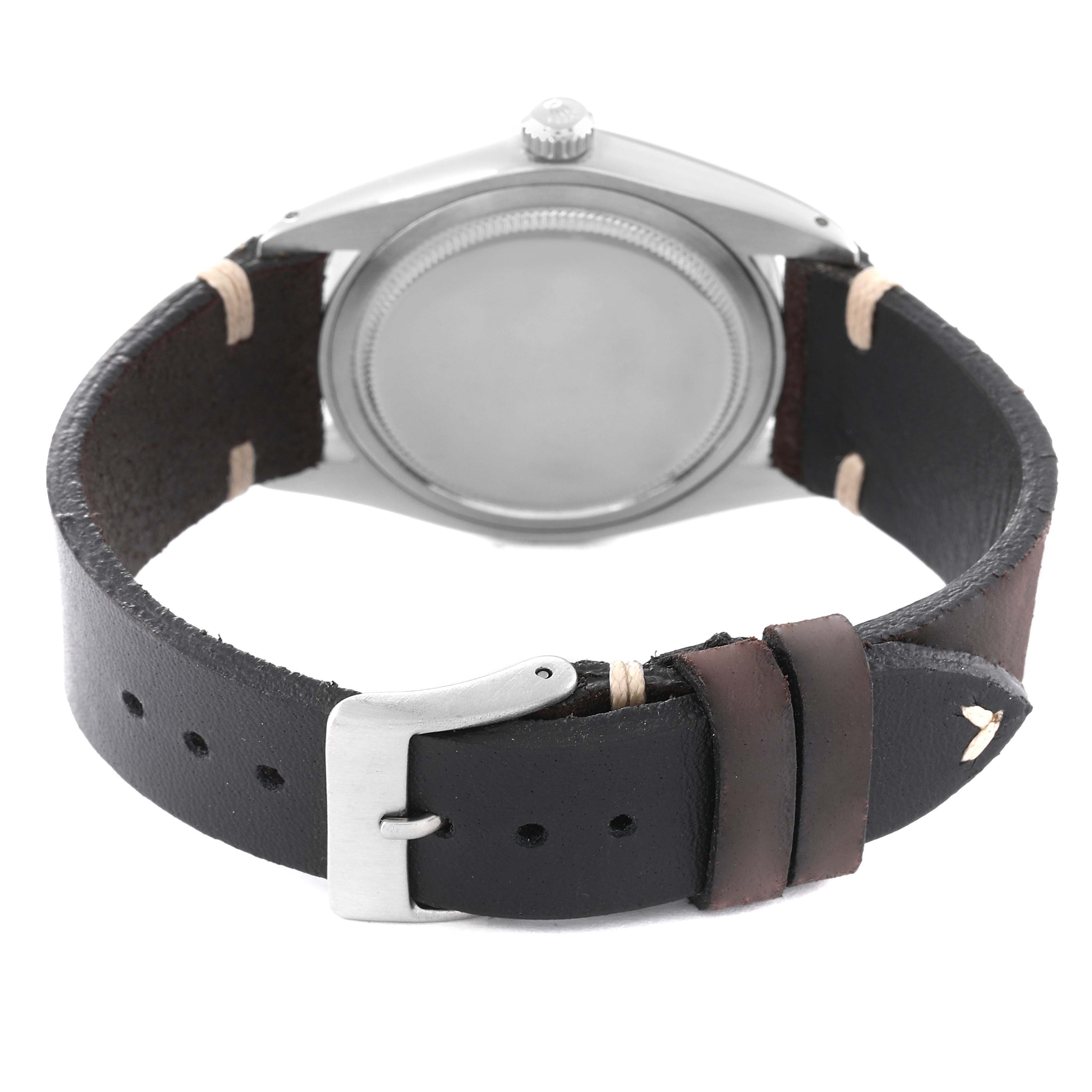 The image shows the back case and leather strap with buckle of a Vintage Collection Rolex watch.