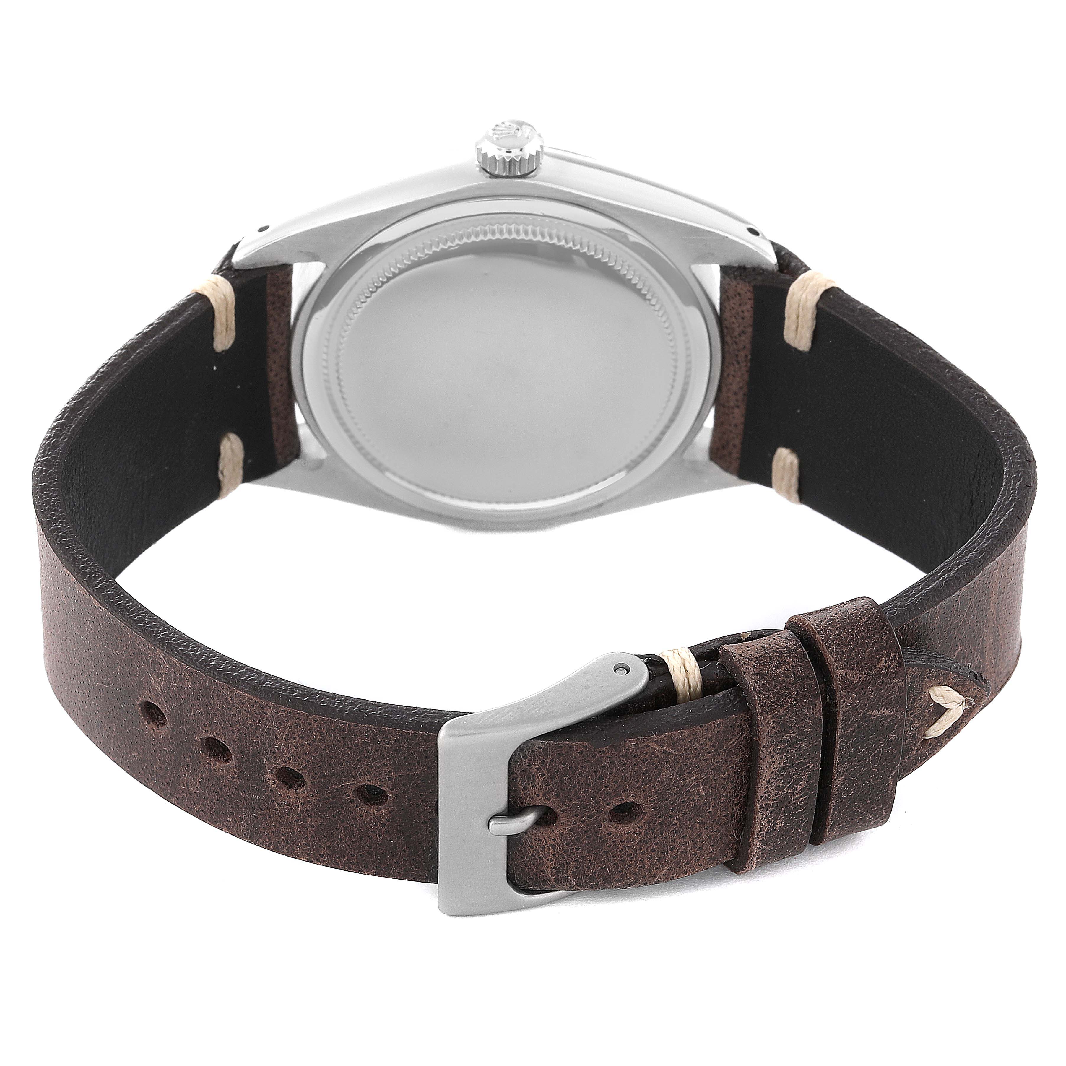 The image shows the back of a Rolex Vintage Collection 6694 Men
s Stainless Steel Silver Dial 6694 Men
s Stainless Steel Silver Dial watch with its leather strap and buckle.