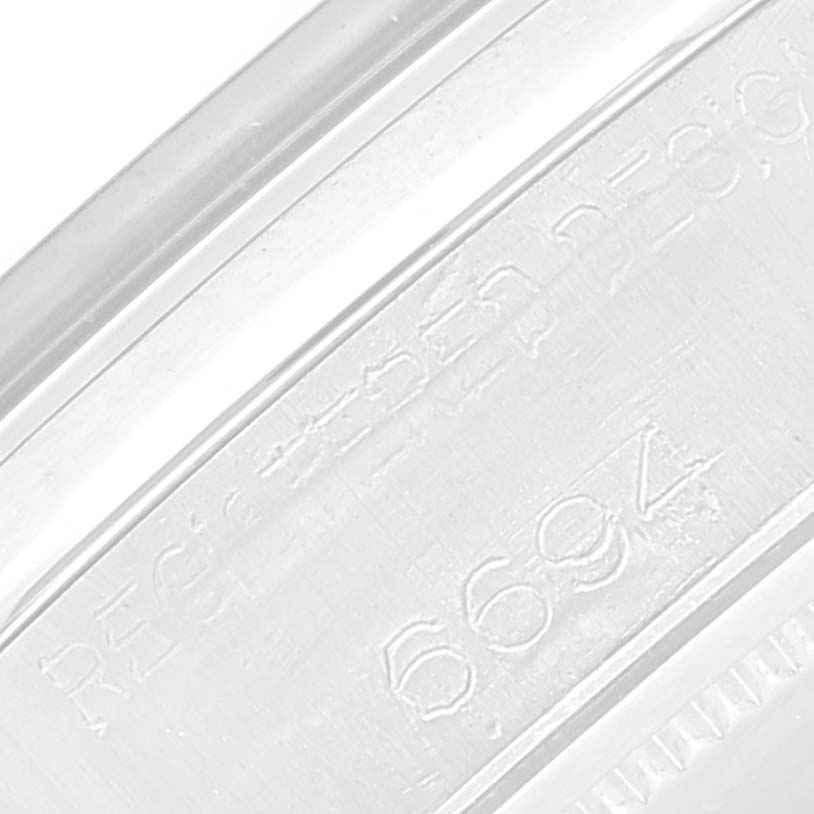 This image shows an engraved serial number on the inner caseback of a Vintage Collection Rolex watch.