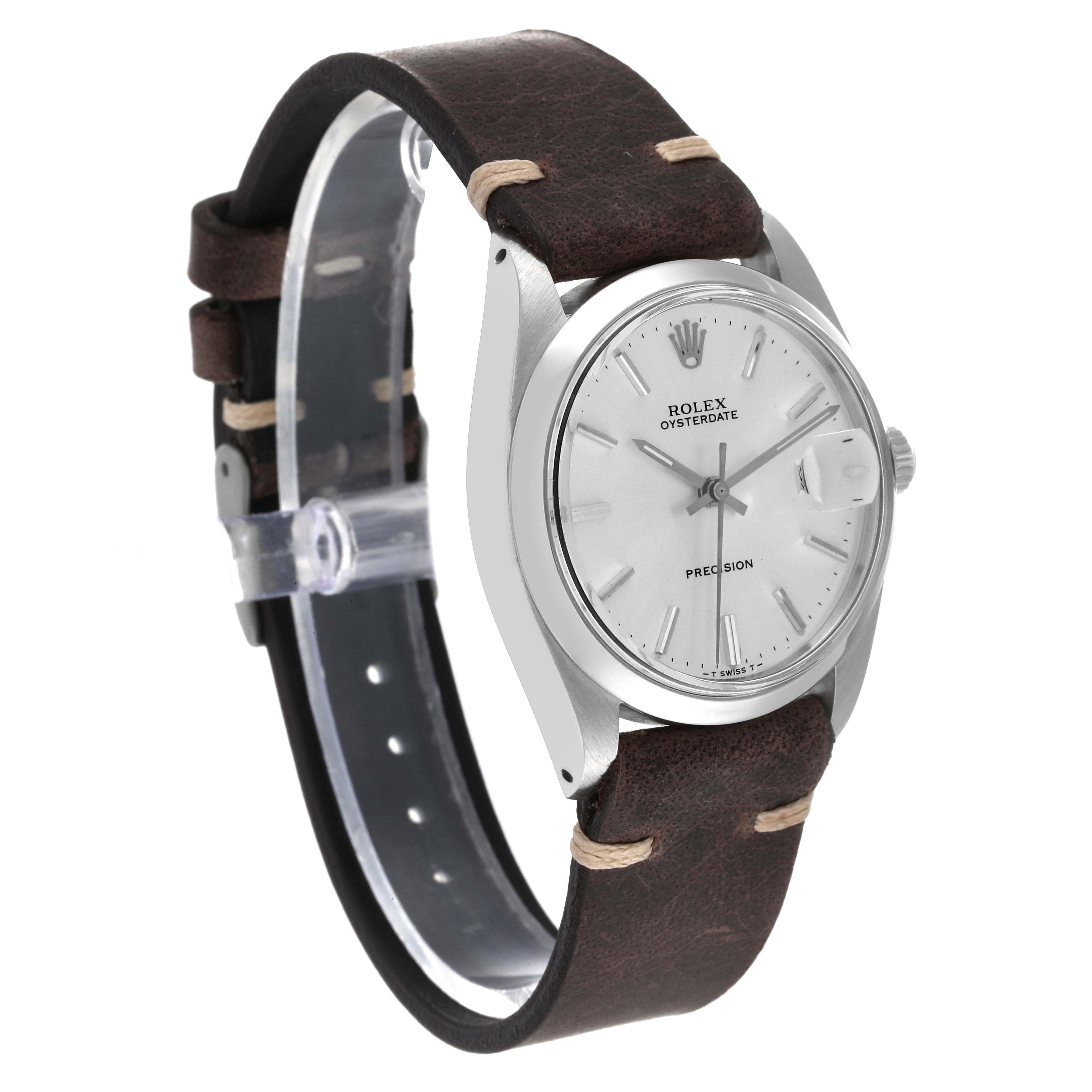 The image shows a side angle of a Rolex Vintage Collection 6694 Men
s Stainless Steel Silver Dial 6694 Men
s Stainless Steel Silver Dial Oysterdate watch with a brown leather strap and a silver dial.