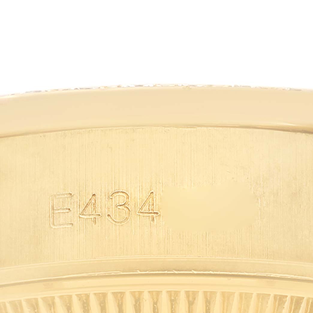 The image shows the side profile of the case back of a Rolex President 69158 Women
s Yellow Gold Champagne Dial 69158 Women
s Yellow Gold Champagne Dial watch, with an engraved serial number.