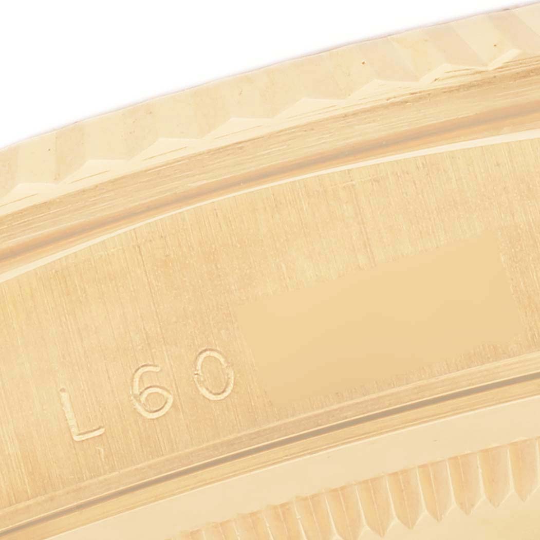 The image shows a close-up of the textured bezel and engraved serial numbers on the side of a Rolex President 18238 Men
s Yellow Gold Champagne Dial 18238 Men
s Yellow Gold Champagne Dial model watch.