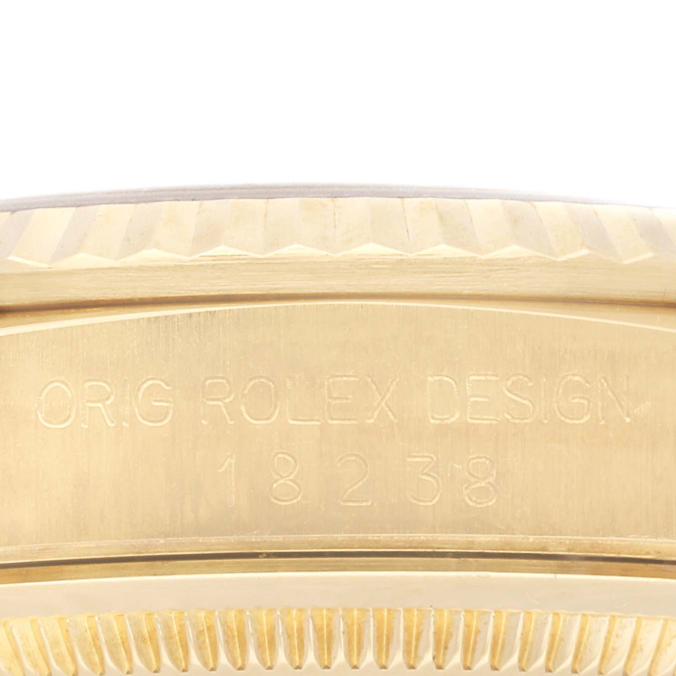 This image shows a close-up of the side of a Rolex President 18238 Men
s Yellow Gold Champagne Dial 18238 Men
s Yellow Gold Champagne Dial model watch, highlighting its gold bezel and engraved model information.