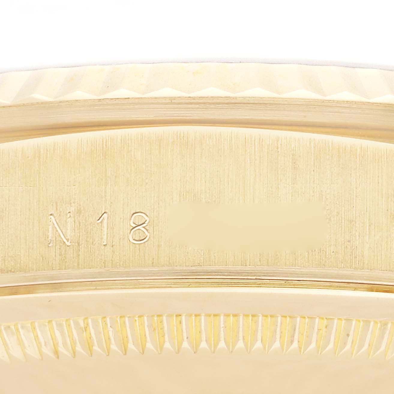 This close-up image shows the side engraving of a Rolex President 18238LR Men's Yellow Gold Champagne Dial 18238LR Men's Yellow Gold Champagne Dial model watch, highlighting its serial number and bezel edge.
