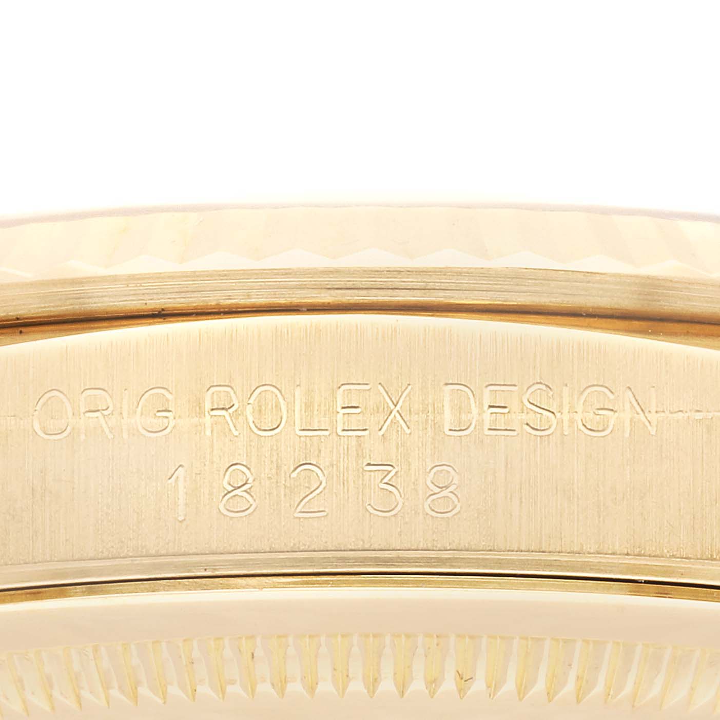This image shows a close-up of the side engraving on the case of a Rolex President 18238LR Men's Yellow Gold Champagne Dial 18238LR Men's Yellow Gold Champagne Dial model watch.