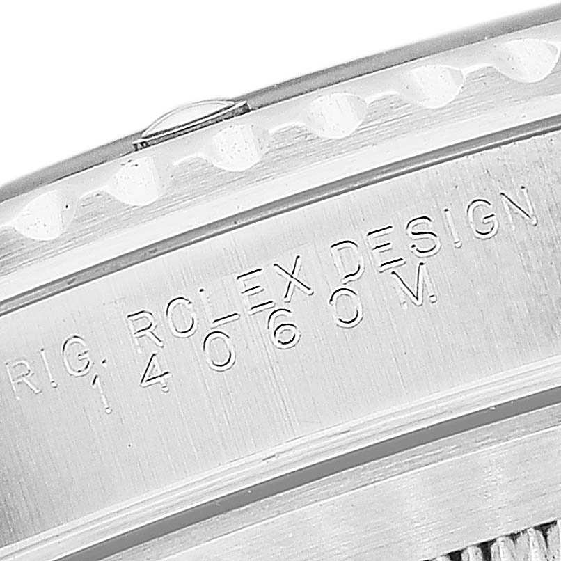 This image shows a close-up angle of the engraved caseback edge of a Rolex Submariner 14060M Men
s Stainless Steel Black Dial 14060M Men
s Stainless Steel Black Dial watch.