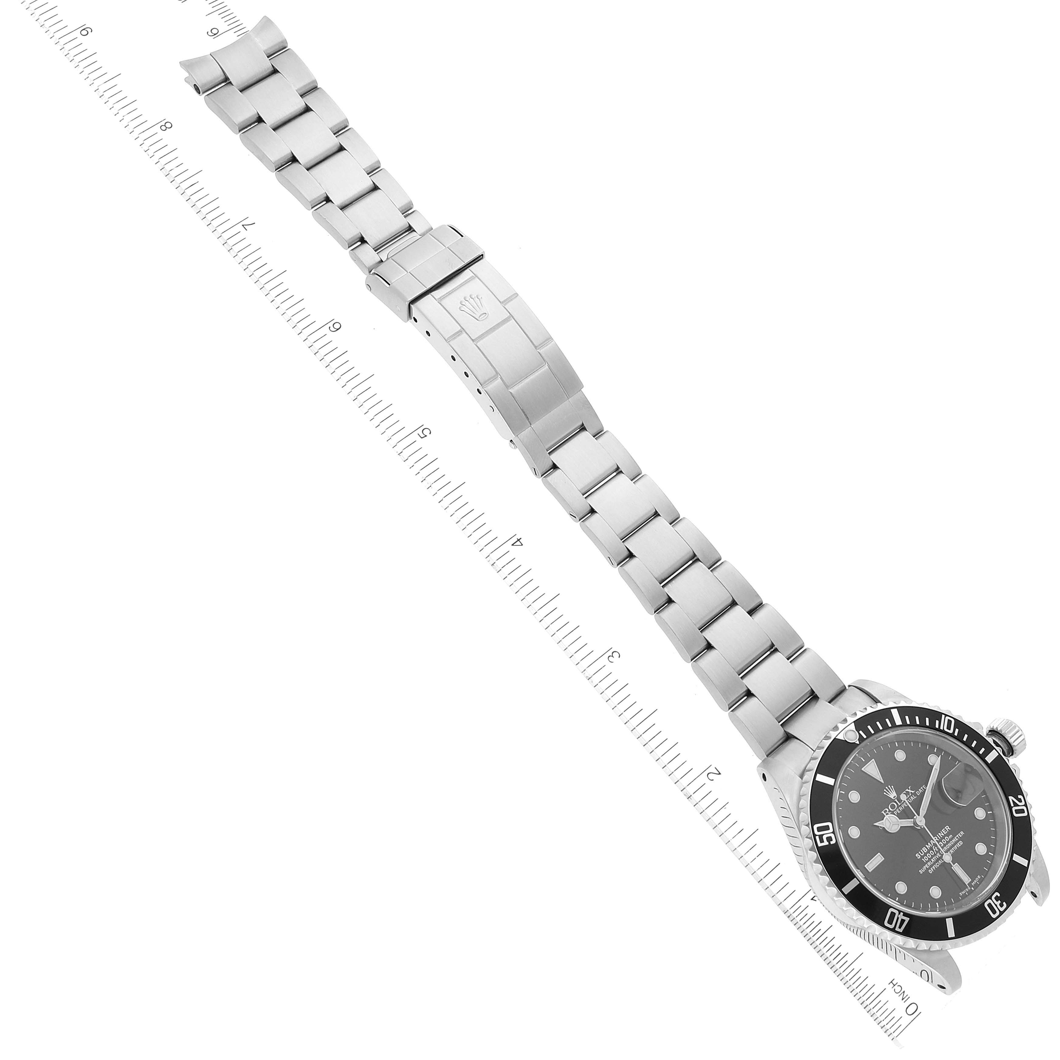 The image shows a Rolex Submariner 16610 Men
s Stainless Steel Black Dial 16610 Men
s Stainless Steel Black Dial watch laid flat with both the face and bracelet visible, at a top-down angle.