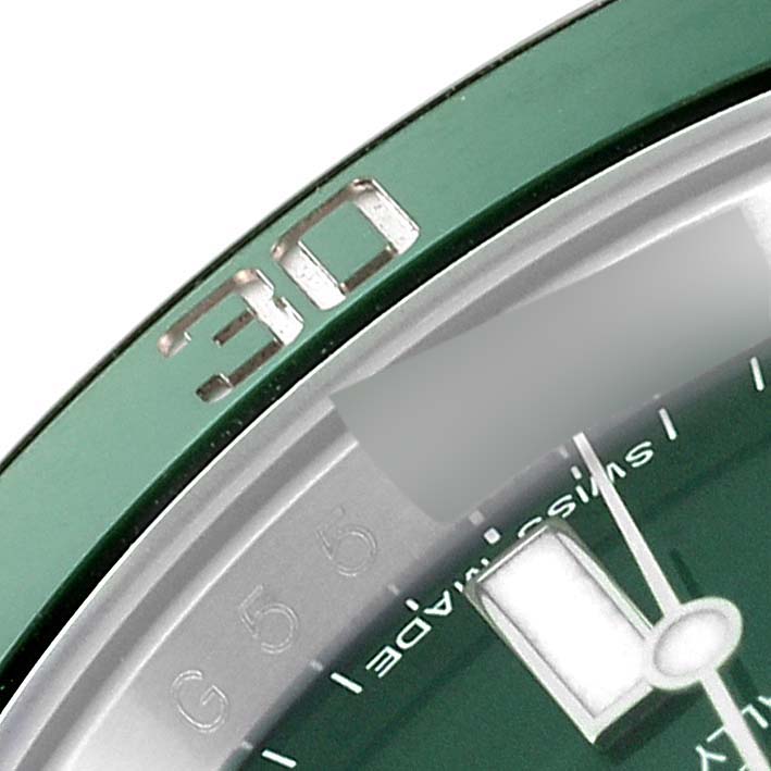 The image shows a close-up of the bezel and a part of the dial of a Rolex Submariner 116610LV Men
s Stainless Steel Green Dial 116610LV Men
s Stainless Steel Green Dial, emphasizing the "30" marker.