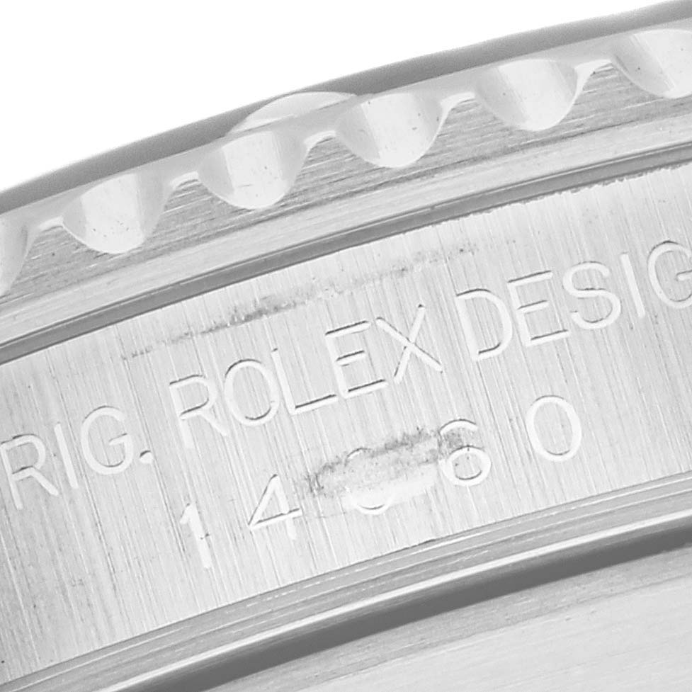 This close-up image of a Rolex Submariner 14060 Men
s Stainless Steel Black Dial 14060 Men
s Stainless Steel Black Dial shows a portion of the watch
s engraved bezel and case back.
