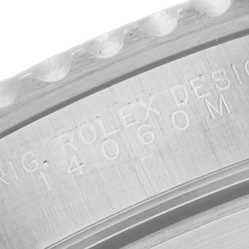 The image shows a close-up of the side engraving on a Rolex Submariner 14060M Men's Stainless Steel Black Dial 14060M Men's Stainless Steel Black Dial watch model 14060M.
