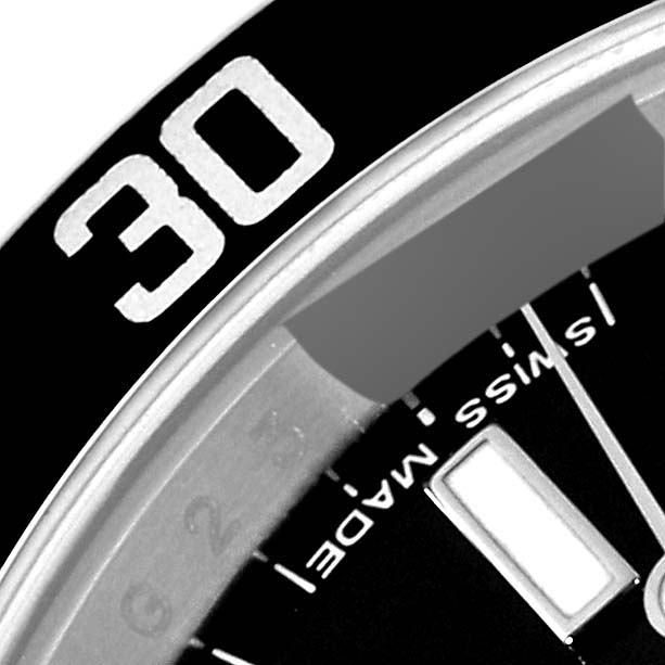 This close-up image shows the bezel and partial dial of a Rolex Submariner 14060M Men
s Stainless Steel Black Dial 14060M Men
s Stainless Steel Black Dial watch, highlighting the "30" minute mark and "Swiss Made" text.