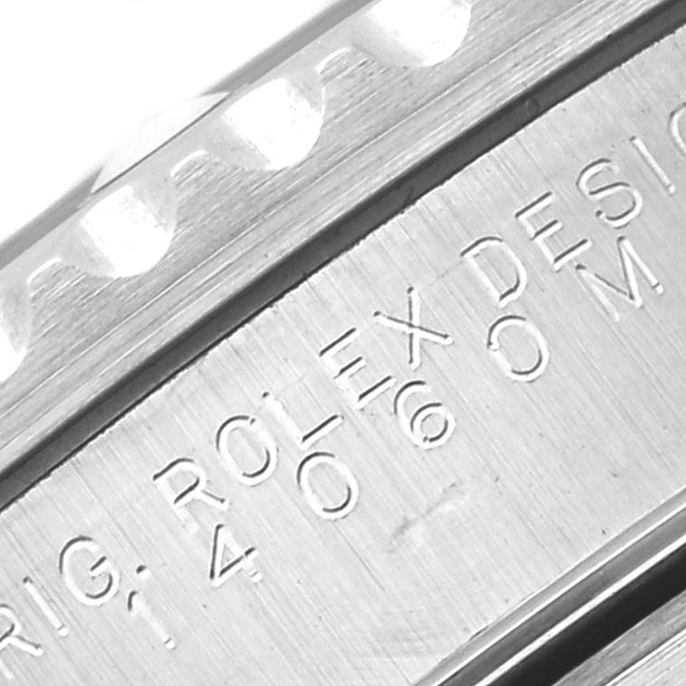 Close-up of the engravings and part of the bezel of a Rolex Submariner 14060M Men
s Stainless Steel Black Dial 14060M Men
s Stainless Steel Black Dial watch.