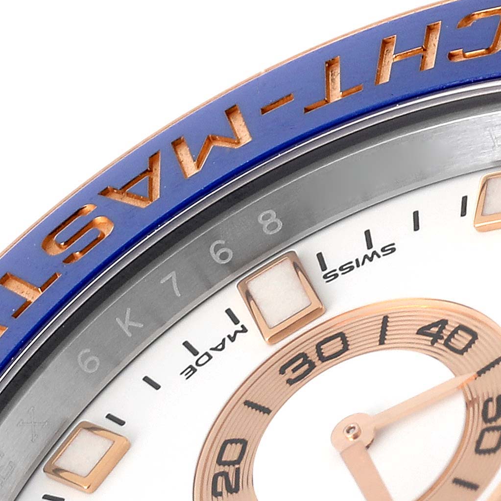 The image shows a close-up of the dial and bezel of a Rolex Yacht-Master 116681 Men
s Steel and Gold (two tone) White Dial 116681 Men
s Steel and Gold (two tone) White Dial watch, highlighting the minute markers and part of the hands.