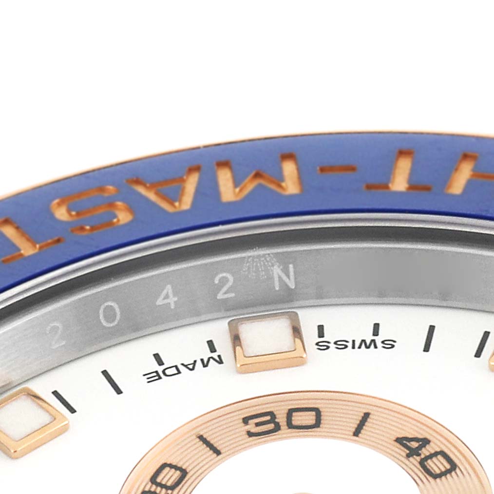 The image shows a close-up of the bezel and part of the dial of a Rolex Yacht-Master 116681 Men
s Steel and Gold (two tone) White Dial 116681 Men
s Steel and Gold (two tone) White Dial watch.
